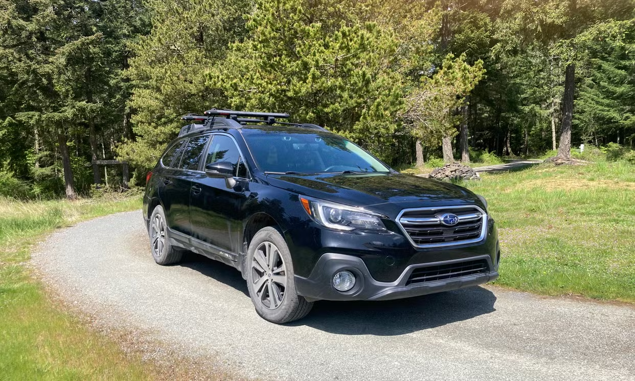 Subaru Outback rental car on Orcas Island with forest background